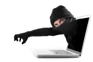 anonymous hacker and cyber criminal man coming out from computer laptop screen with grabbing and stealing hand in black glove as conceptual password hacking and cyber crime